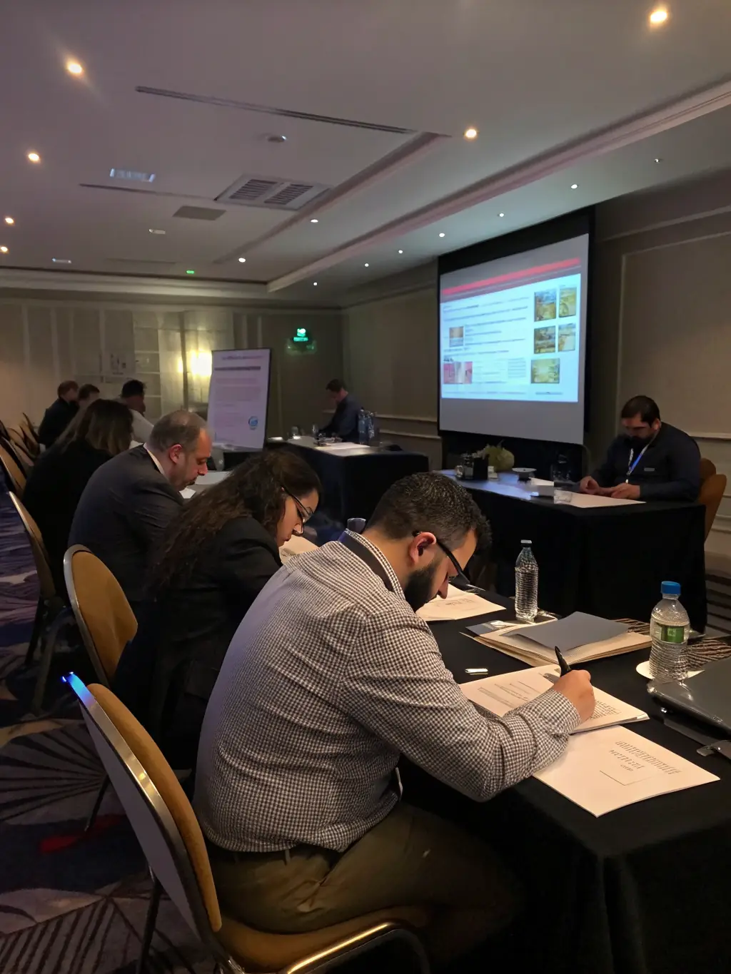 A group of professionals participating in an IT training session, with a focus on hands-on learning and practical application of new skills, used to represent Bessa Consultores' IT training programs.